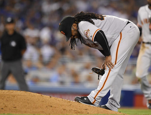 San Francisco Giants starting pitcher Johnny Cueto winces after injuring himself during the sixth inning of a baseball game against the Los Angeles Dodgers Tuesday Sept. 20 2016 in Los Angeles. Cueto was taken out of the