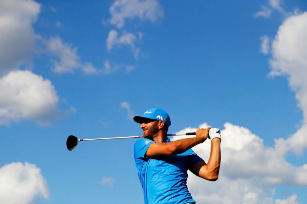 Dustin Johnson tees off during second-round play at the Tour Championship on Friday. Johnson leads the tournament by one shot over Kevin Chappell