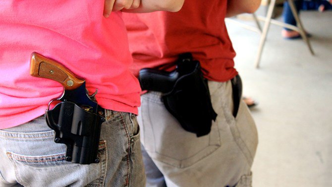 Gun owners wearing their weapons on holsters