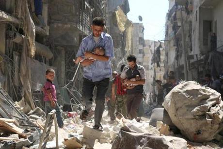 Syrian men carried babies through the rubble of destroyed buildings following a reported airstrike on the rebel-held Salihin neighborhood of Aleppo on Sunday