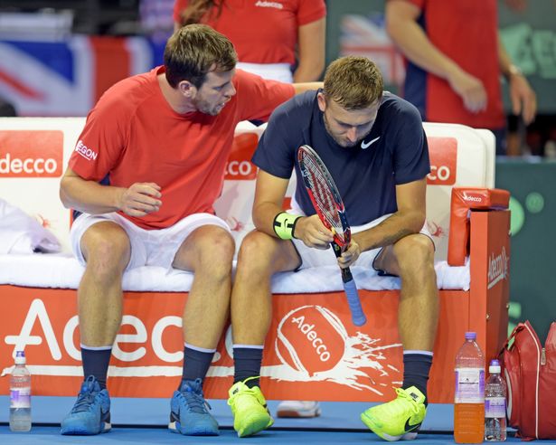 Great Britain captain Leon Smith consoles Dan Evans after he loses the third set