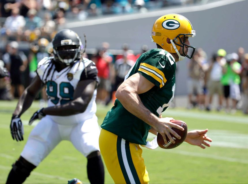 Green Bay Packers quarterback Aaron Rodgers runs