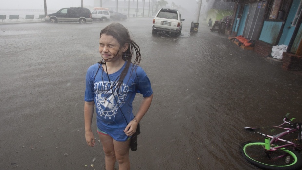 Hannah Coles 9 takes a break from riding her bike to feel a strong rain shortly Thursday afternoon Sept. 1 2016 in Gulfport Fla. Tropical Storm Hermine strengthened into a hurricane Thursday and steamed toward Florida's Gulf Coast