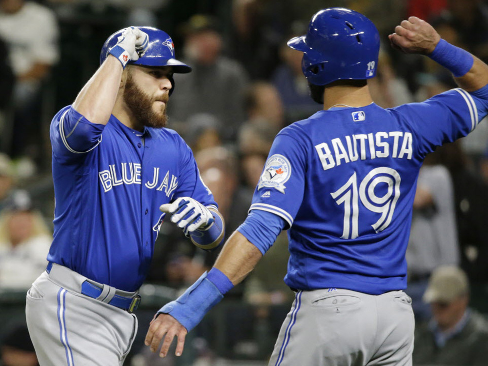 Toronto Blue Jays&#039 Russell Martin left is greeted at the plate by Jose Bautista right after Martin's two-run home run