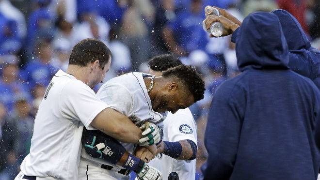 Seattle Mariners&#039 Mike Zunino left holds Robinson Cano as other players douse Cano with water after his game-winning sacrifice fly against the Toronto Blue Jays in a baseball game in Seattle on Wednesday Sept. 21 2016