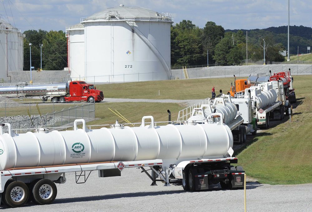 Tanker trucks line up at a Colonial Pipeline Co. facility in Pelham Ala. near the scene of a 250,000-gallon gasoline spill on Friday Sept. 16 2016. The company says spilled gasoline is being taken to the storage facility for storage. Some motorists