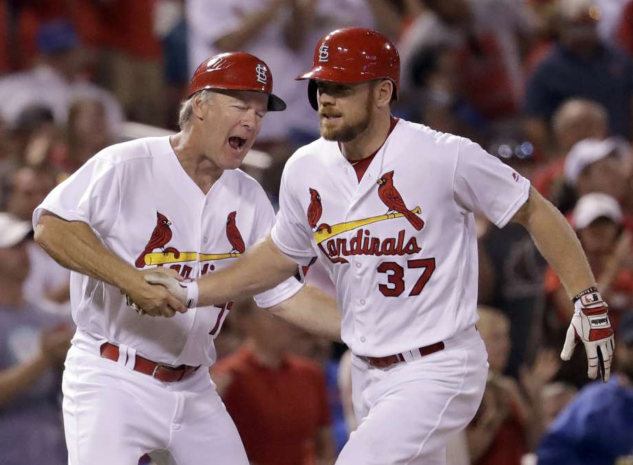 St. Louis Cardinals Brandon Moss right is congratulated by third base coach Chris Maloney while rounding the bases after hitting a two-run home run during the sixth inning of a baseball game against the Chicago Cubs Tuesday Sept. 13 2016 in St. Lou