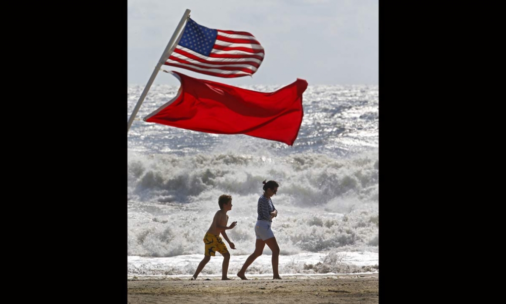 Beachgoers walk away from big waves and rough surf caused by Hermine Sunday Sept. 4 2016 in Bradley Beach New Jersey