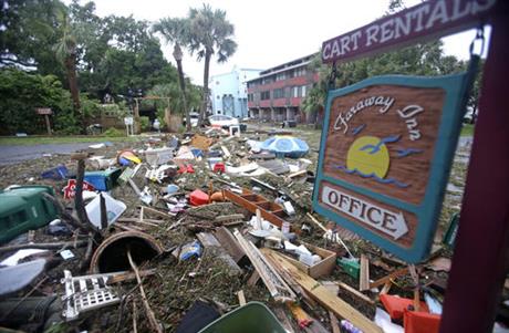 A street is blocked from debris washed up from the tidal surge of Hurricane Hermine Friday Sept. 2 2016 in Cedar Key Fla. Hermine was downgraded to a tropical storm after it made landfall