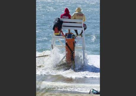 Lifeguards at Nantucket’s Surfside Beach watch as the tide overtakes their lifeguard stand as Hermine creeps up the coast on Sunday Sept. 4