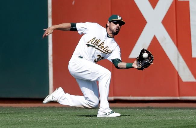 Oakland Athletics center fielder Brett Eibner makes a sliding catch on a fly ball from Seattle Mariners&#39 Dae Ho Lee during the eighth inning of a baseball game Sunday Sept. 11 2016 in Oakland Calif