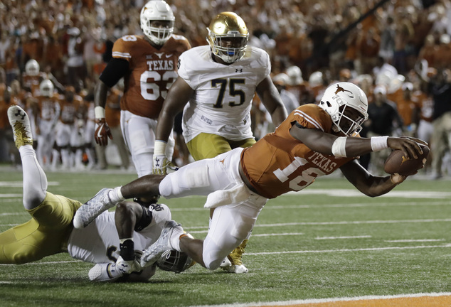 Texas quarterback Tyrone Swoopes dives for a touchdown during the second overtime of an NCAA college football game against Notre Dame Sunday Sept. 4