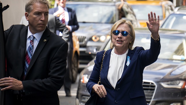 Democratic presidential candidate Hillary Clinton walks from her daughter's apartment building Sunday Sept. 11 2016 in New York. Clinton unexpectedly left Sunday's 9/11 anniversary ceremony in New York after feeling'overheated' according