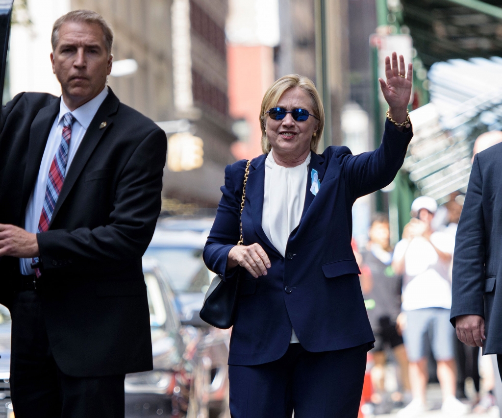 Hillary Clinton emerges after a short rest at her daughter's apartment following 9/11 memorial dizzy spell