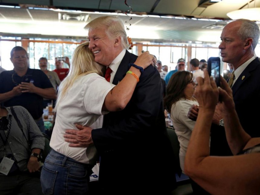 Republican presidential nominee Donald Trump is hugged by supporter Tracy Mc Cullough during a campaign stop at the Boulevard Diner in Dundalk Maryland