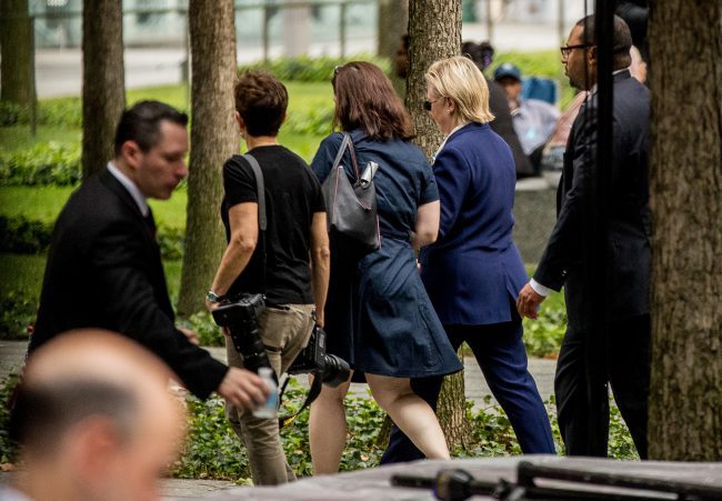 Democratic presidential candidate Hillary Clinton second from right departs after attending a ceremony at the Sept. 11 memorial in New York Sunday Sept. 11 2016 on the 15th anniversary of the Sept. 11 attacks