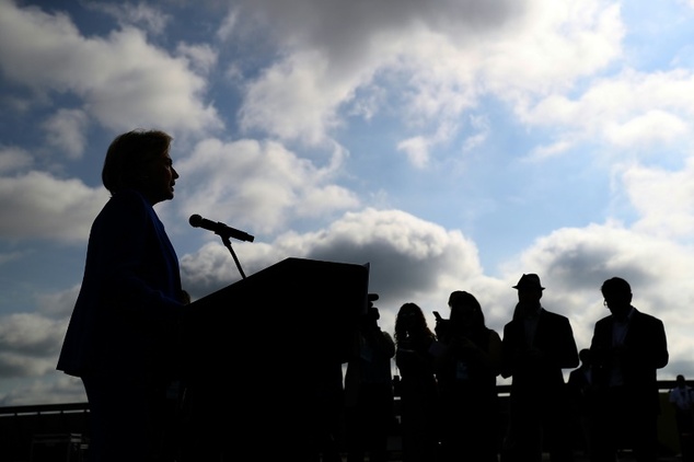 Democratic presidential candidate Hillary Clinton speaks to reporters on the tarmac at Westchester County Airport