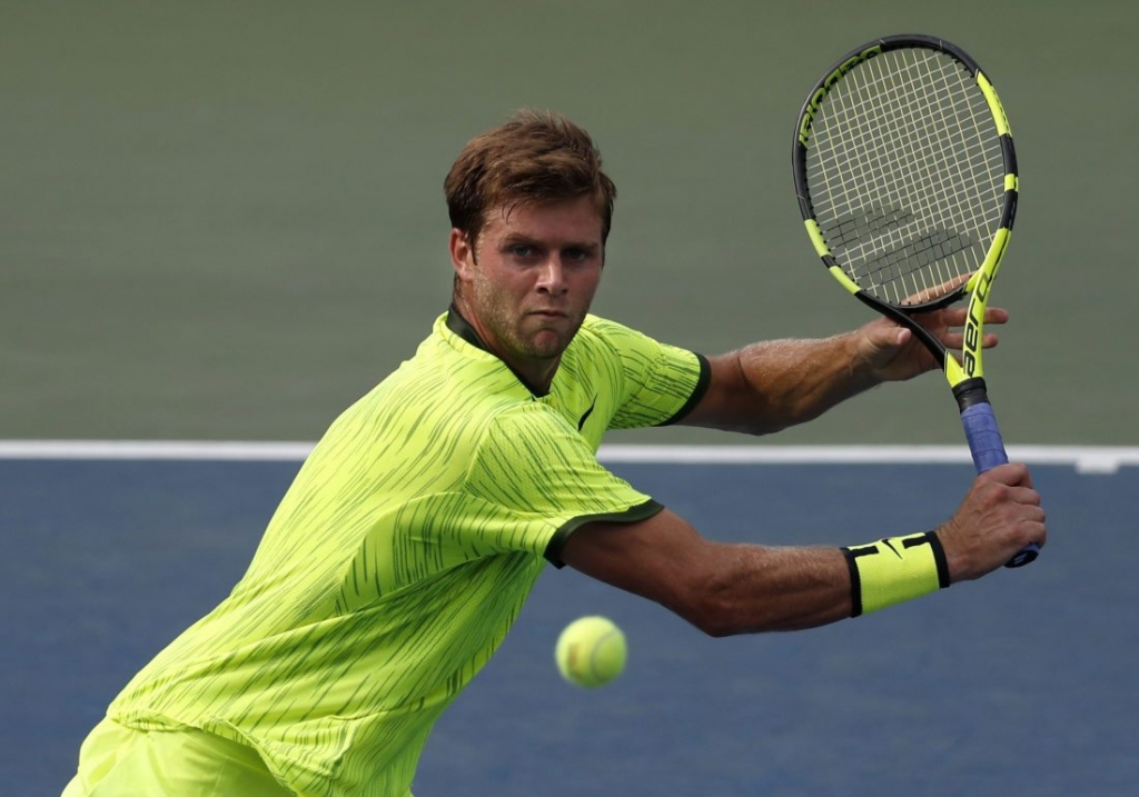 Ryan Harrison of the United States returns a shot to Milos Raonic of Canada during the second round of the U.S. Open tennis tournament Wednesday Aug. 31 2016 in New York