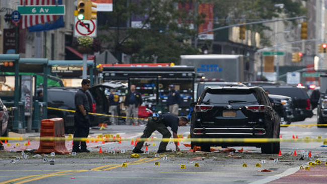 Crime scene investigators work at the scene of Saturday's explosion in Manhattan's Chelsea neighborhood in New York Sunday Sept. 18 2016