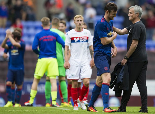 Manchester United's Portuguese manager Jose Mourinho congratulates Manchester United's English striker Will Keane following the pre-season friendly football match between Wigan Athletic and Manchester United at the DW stadium in Wigan northwest Engla