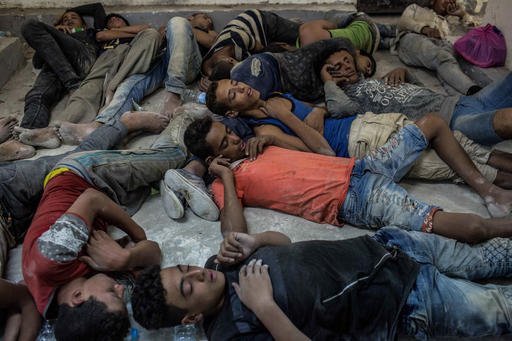 Young Egyptians detained at a police station sleep on the floor in Rosetta Egypt after rescued from a boat capsized off the Mediterranean coast near the Egyptian city of Alexandria Wednesday Sept. 21 2016. Egypt's official news agency MENA said the