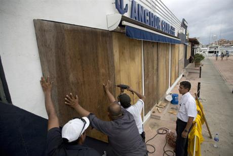 Workers board over a store front in preparation for Hurricane Newton in Cabo San Lucas Mexico Monday Sept. 5 2016. Authorities at the southern end of Mexico's Baja California peninsula ordered schools closed and set up emergency shelters as Hurri