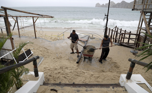 Two men shovel sand deposited by Hurricane Newton from inside a restaurant in Cabo San Lucas Mexico Tuesday Sept. 6 2016. Hurricane Newton shattered wind