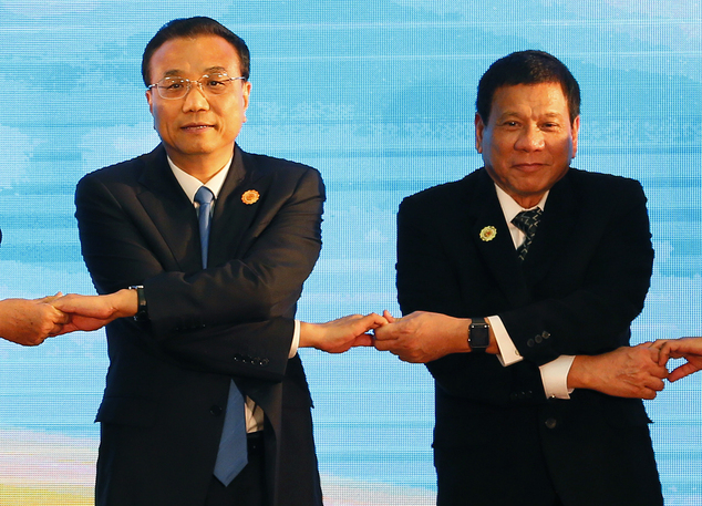 Chinese Premier Li Keqiang left and Philippine President Rodrigo Duterte link their hands during the ASEAN Plus Three summit in the ongoing 28th and 29th A