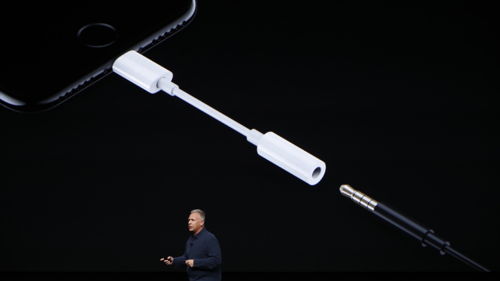 Apple Senior Vice President of Worldwide Marketing Phil Schiller introduces a Lightning to 3.5 mm audio jack adapter during a launch event