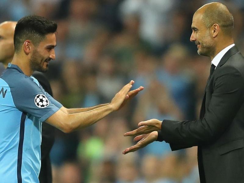 Ilkay Gundogan with his manager Pep Guardiola