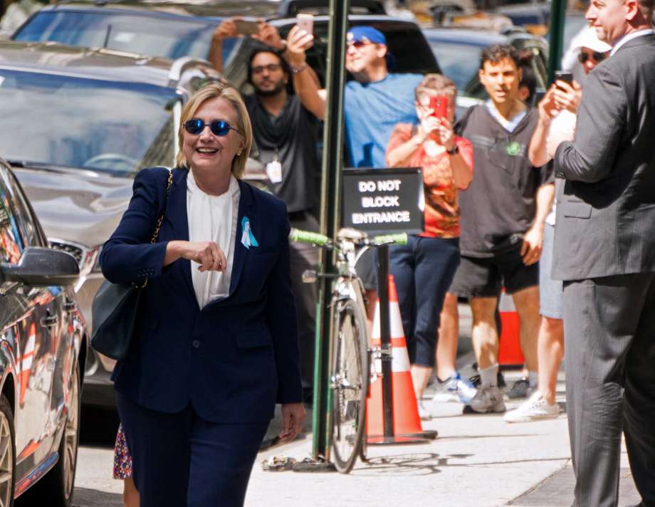 Democratic presidential candidate Hillary Clinton walks from from her daughter's apartment building Sunday Sept. 11 2016 in New York. Clinton unexpectedly left Sunday's 9/11 anniversary ceremony in New York after feeling'overheated' according to her