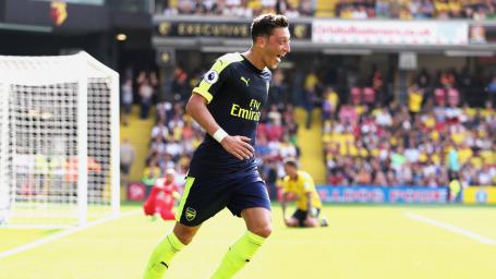 Image Text
 HEAD BOY Mesut Ozil celebrates his team's third goal