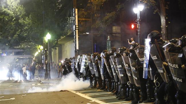 US police clash with protesters as residents and activists protest the death of Keith Scott