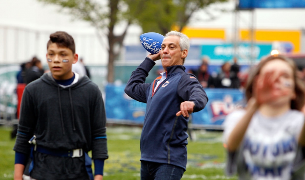 Chicago Mayor Rahm Emanuel throws a football during an NFL event in Chicago