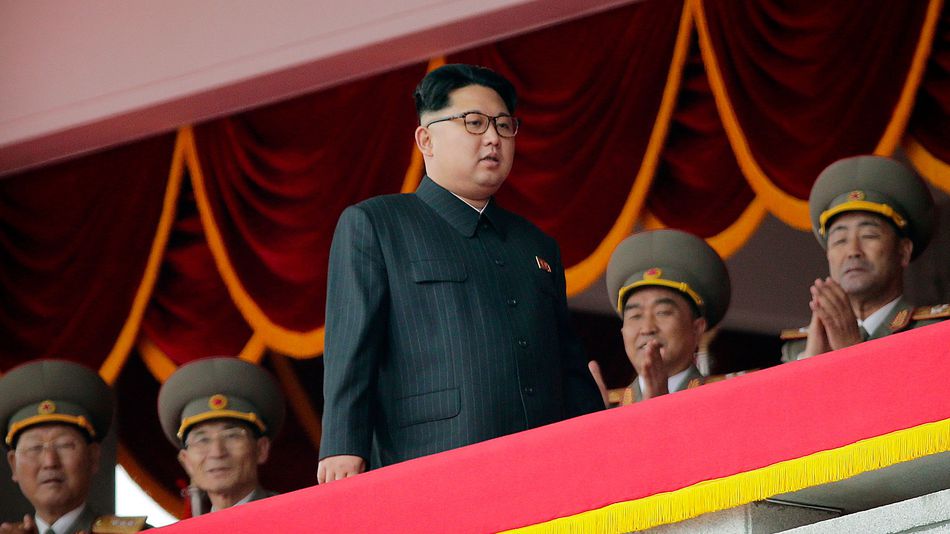 North Korean leader Kim Jong Un center watches a parade from a balcony