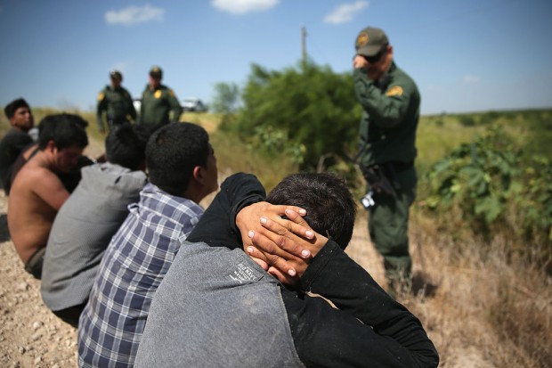 U.S. Border Patrol agents detain undocumented immigrants after they crossed the border from Mexico into the United States