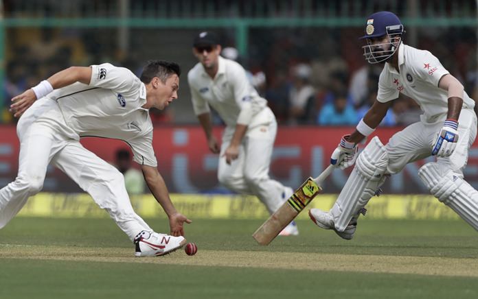 New Zealand's Trent Boult left fields a shot from India's Lokesh Rahul right during the first test in Kanpur India Thursday Sept. 22