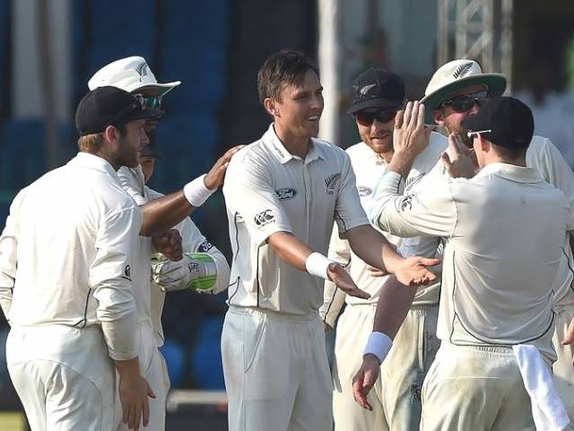 New Zealand's Trent Boult celebrates the wicket of India's Wriddhiman Saha with teammates during the first day of the first Test match between India and New Zealand at Green Park Stadium in Kanpur