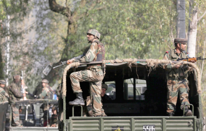 Indian soldiers guard outside the army base which was attacked Sunday by suspected militants at Uri Indian controlled Kashmir on Monday. — AP