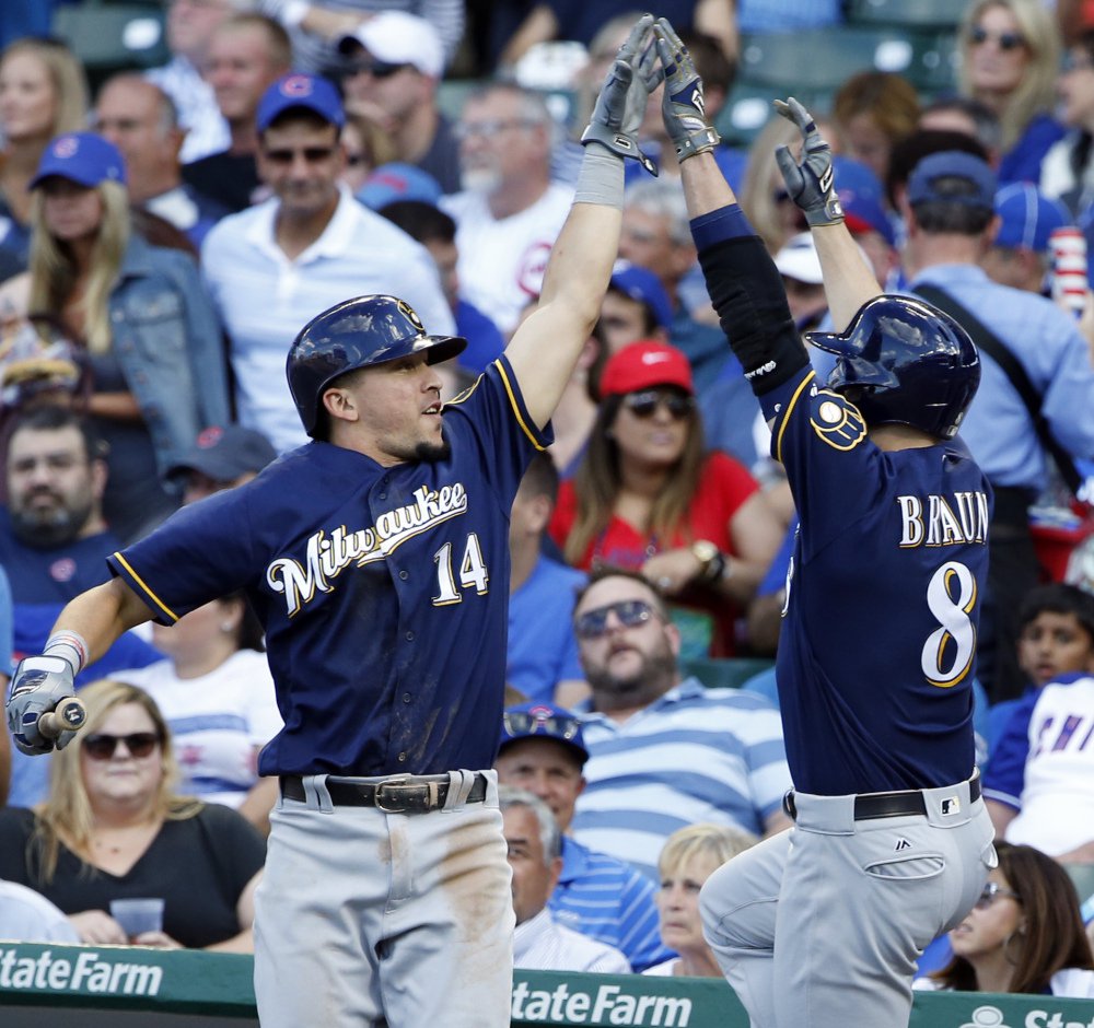 Milwaukee's Ryan Braun right celebrates with Hernan Perez after hitting a two-run homer in the sixth inning of the Brewers 11-3 win against the Cubs in Chicago