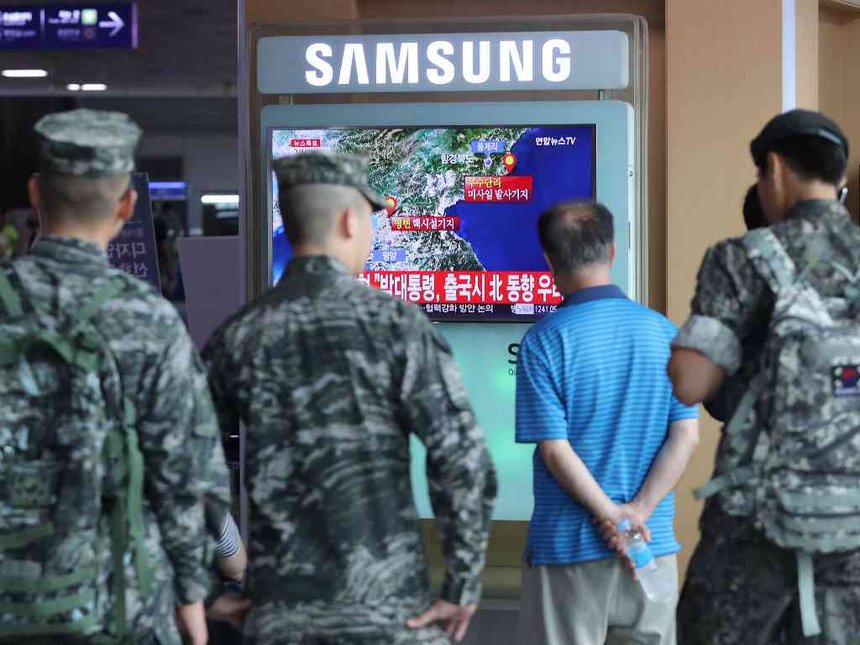 South Korean soldiers and passenger watch a TV broadcasting a news report on Seismic activity produced by a suspected North Korean nuclear test at a railway station in Seoul South Korea