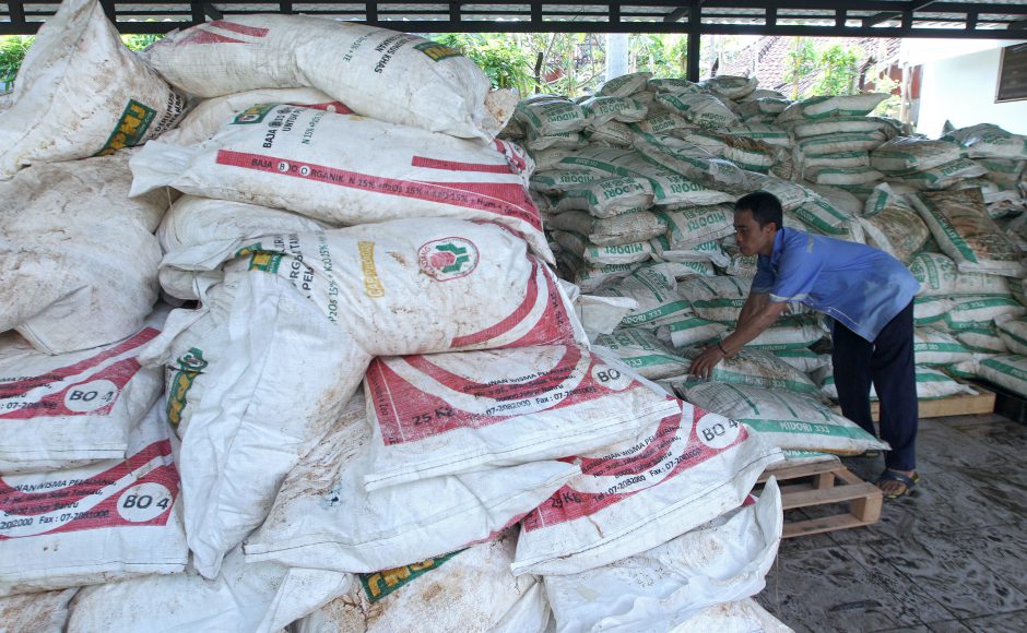 A worker arranges stacks of fertilizer confiscated from a ship detained by a local authority at the Customs office in Bali Indonesia Thursday Sept. 22 2016. Pic AP