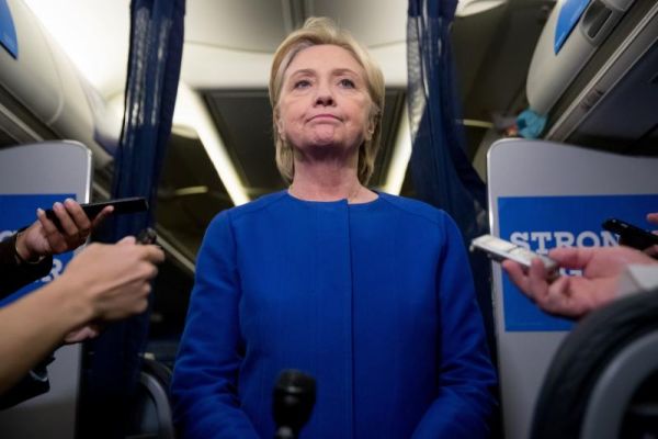 Democratic presidential candidate Hillary Clinton pauses while she