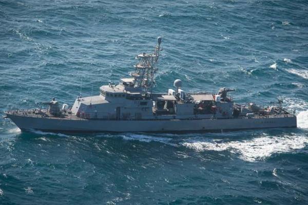 The patrol craft USS Squall steams in the Arabian Gulf acting as a small boat threat toward guided-missile destroyer USS Mitscher during a simulated strait transit