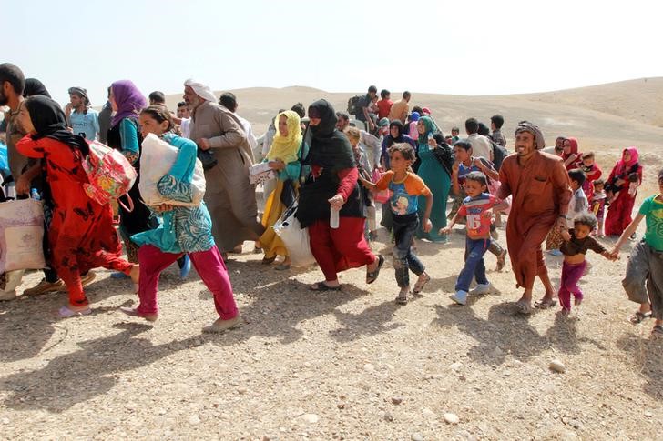 Sunni Muslims who fled the Islamic State's strongholds of Hawija and Shirqat arrive at the town of Dibis northwest of Kirkuk Iraq