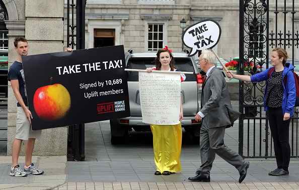 A protester demonstrates in support of EU ruling against Apple outside parliament building in Dublin