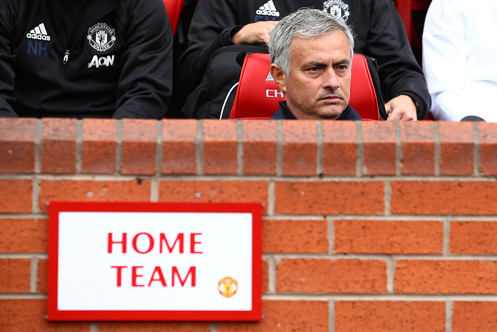 MANCHESTER ENGLAND- SEPTEMBER 10 Jose Mourinho Manager of Manchester United sits in the home team dugout during the Premier League match between Manchester United and Manchester City at Old Trafford