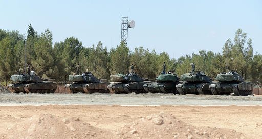 Turkish tanks stationed near the Syrian border in Karkamis Turkey Saturday Sept. 3 2016. Turkey's state-run news agency says Turkish tanks have entered Syria's Cobanbey district northeast of Aleppo in