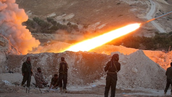 Free Syrian Army fighters launch a Grad rocket from Halfaya town in Hama province towards forces loyal to Syria