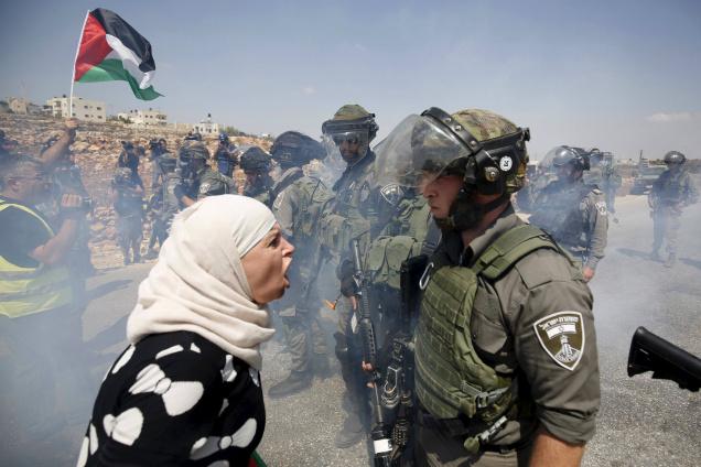 A Palestinian woman arguing with an Israeli border policeman during a protest against Jewish settlements in a West Bank village near Ramallah last year. File